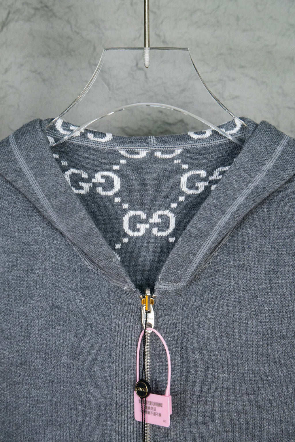 Heather gray hoodie neck with logo print hood lining and zipper pull tag