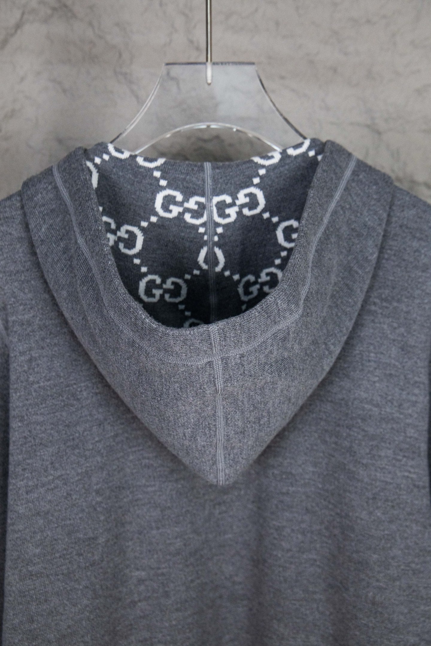 Heather gray zip-up hoodie with hood and dark logo print lining