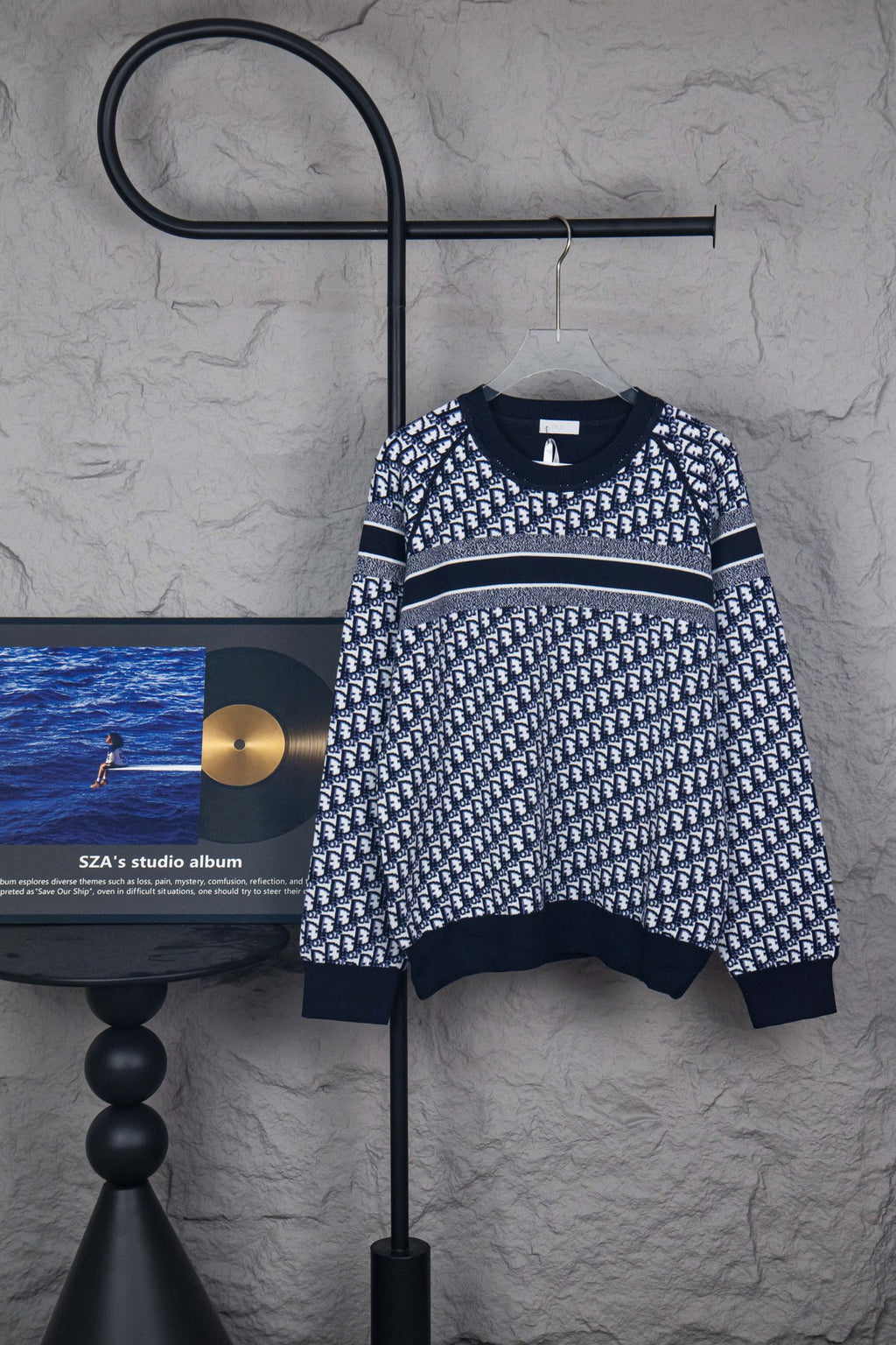 Long-sleeve knit sweater in dark blue with allover monogram pattern and striped hem