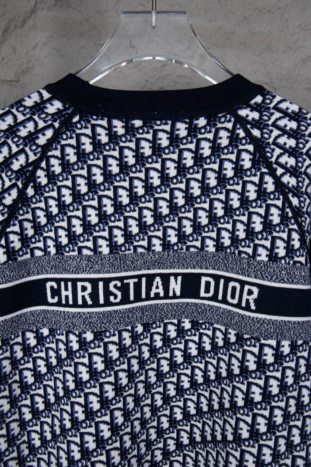 Long-sleeve knit sweater on hanger with CHRISTIAN DIOR logo stripe and monogram knit