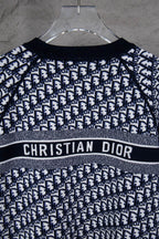 Long-sleeve knit sweater on hanger with CHRISTIAN DIOR logo stripe and monogram knit