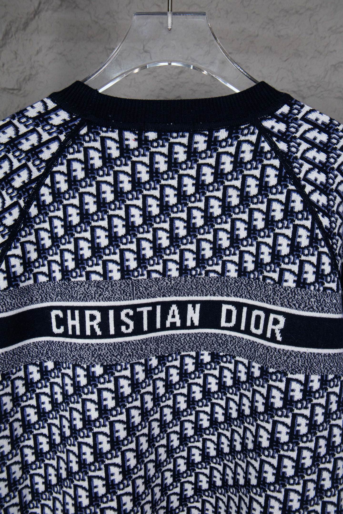 Long-sleeve knit sweater on hanger with CHRISTIAN DIOR logo stripe and monogram knit