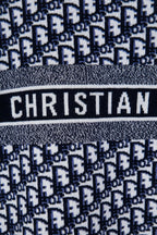 Knit sweater band detail with CHRISTIAN text on striped logo panel