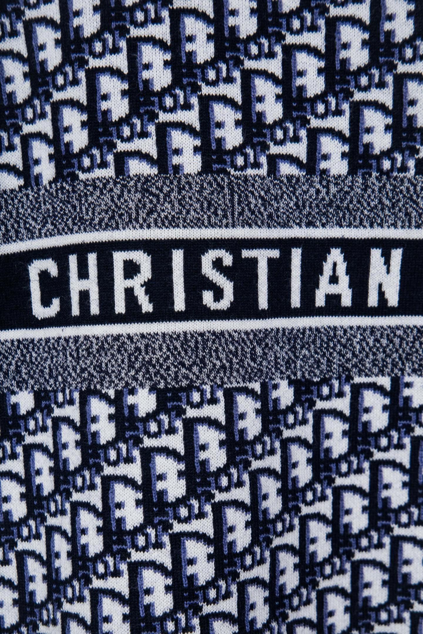Knit sweater band detail with CHRISTIAN text on striped logo panel