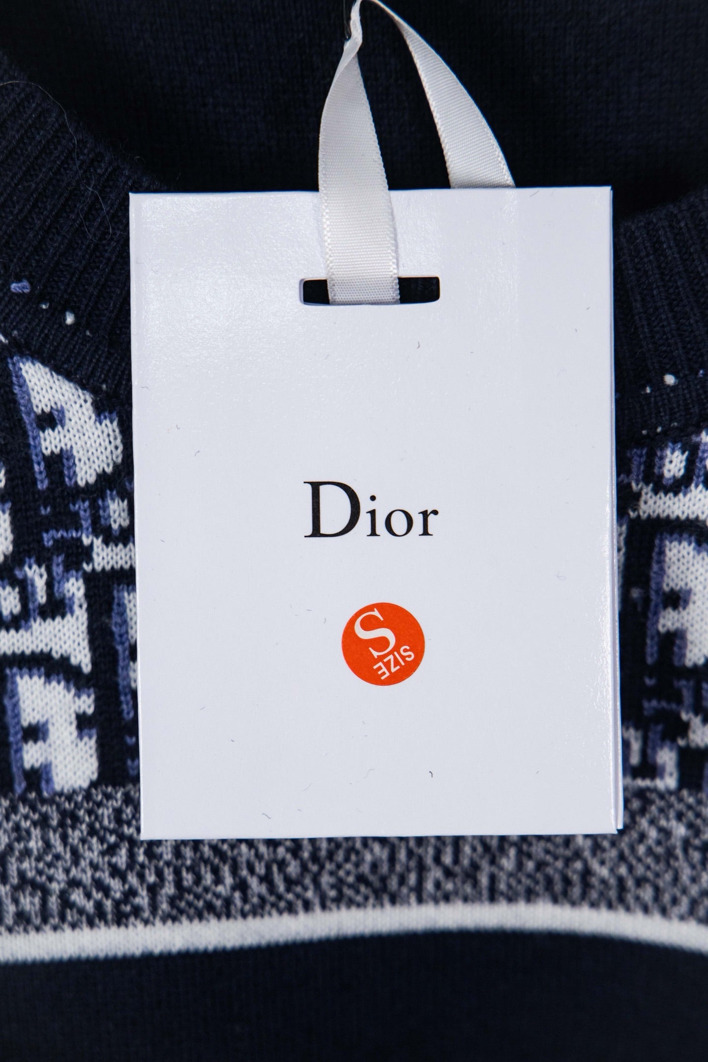 Brand label on interior tag of knit sweater marked Dior