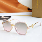 Sunglasses with light pink frames and gold-tone arms, pale tint lenses