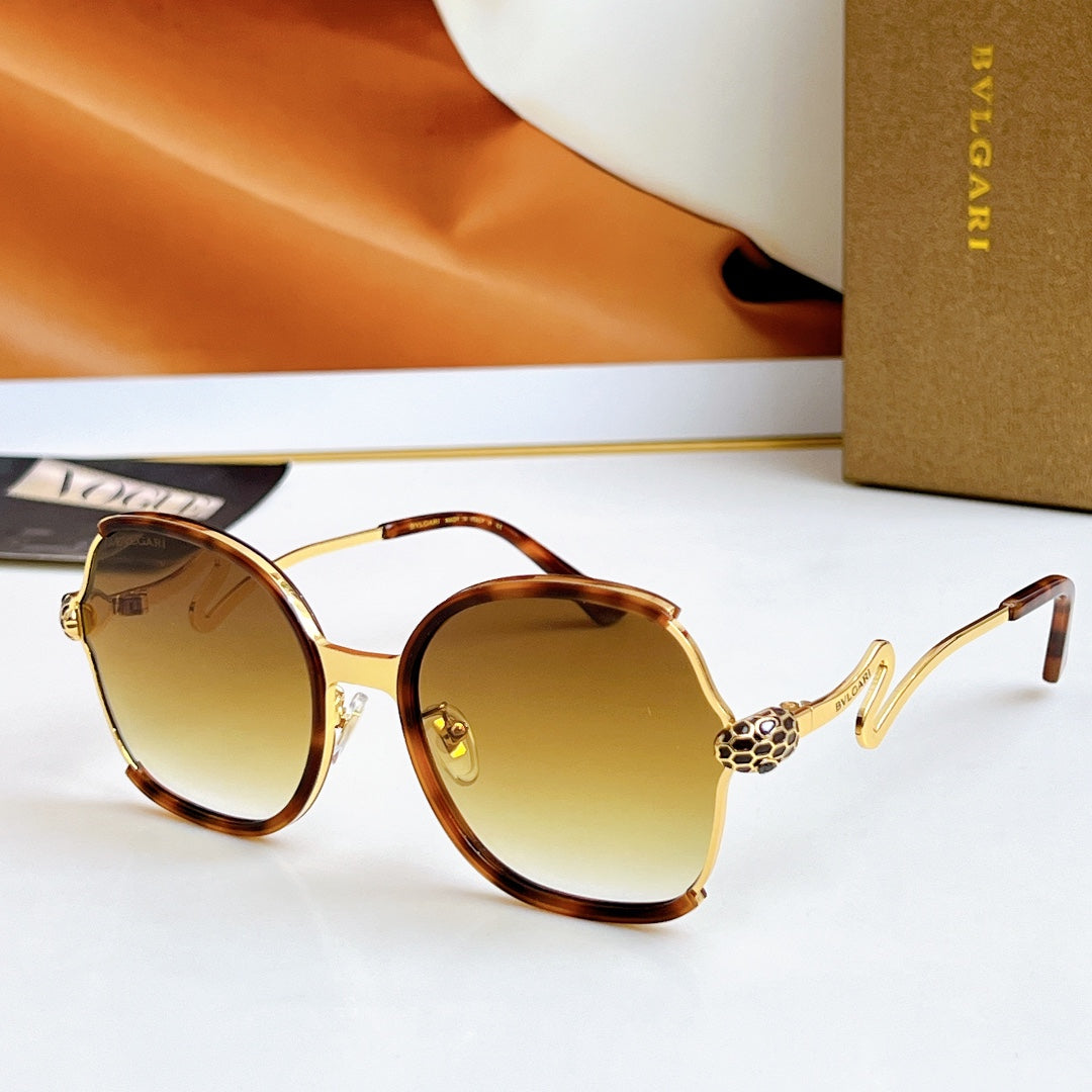 Sunglasses with tortoiseshell frames and gold-tone arms, brown gradient lenses