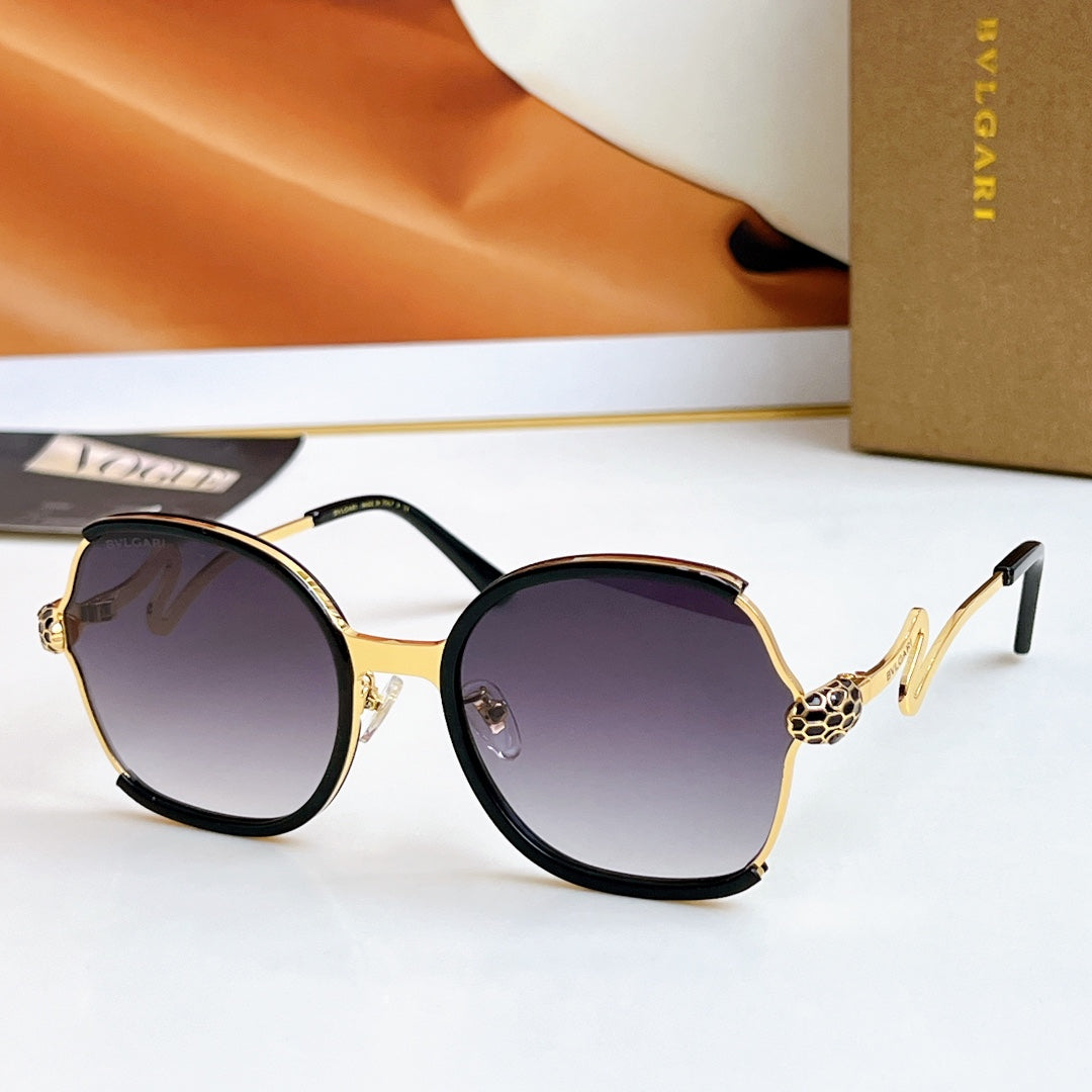 Sunglasses with tortoiseshell frames and gold-tone arms, dark purple tinted lenses
