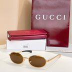 Gucci sunglasses with brown lenses and gold-tone round frames