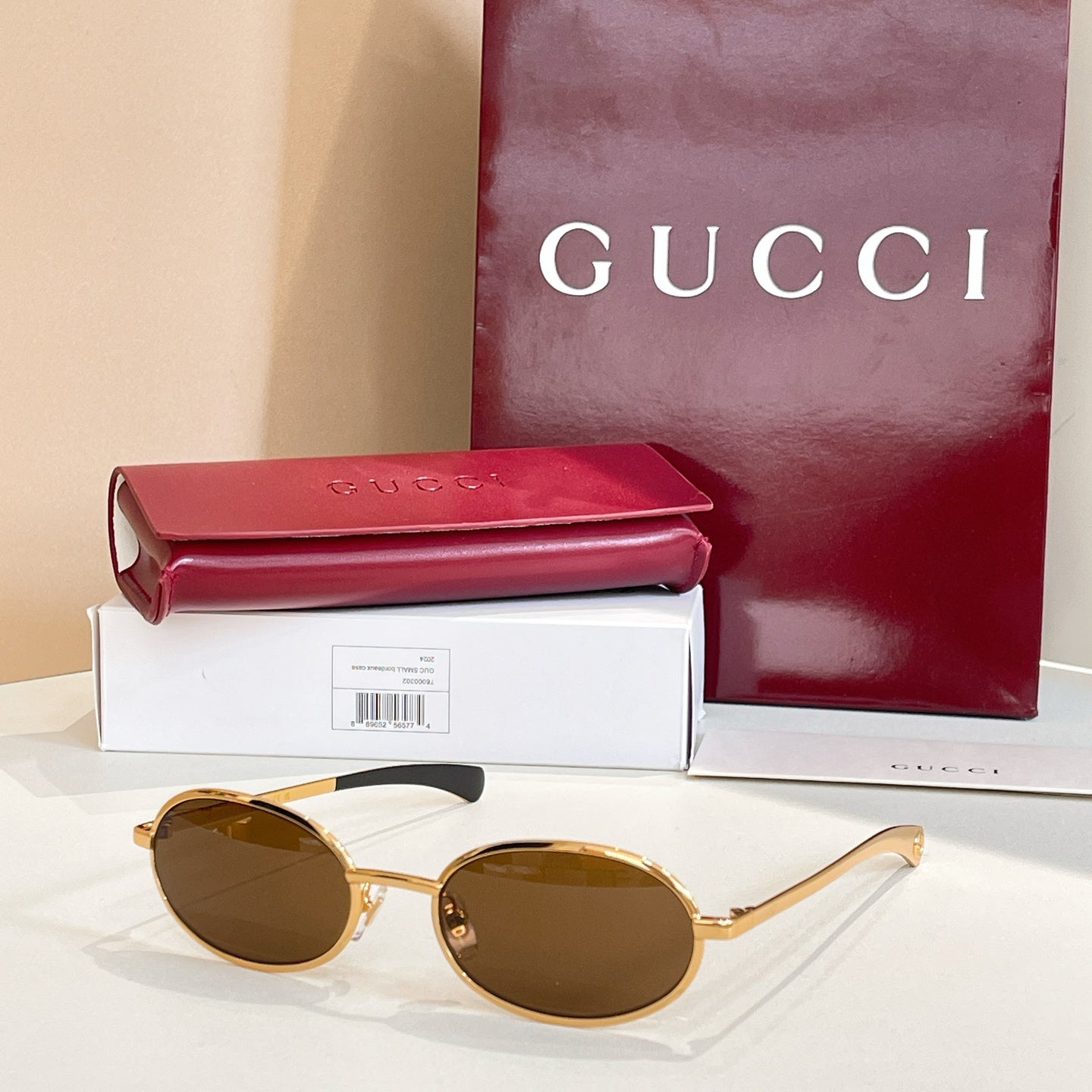 Gucci sunglasses with brown lenses and gold-tone round frames