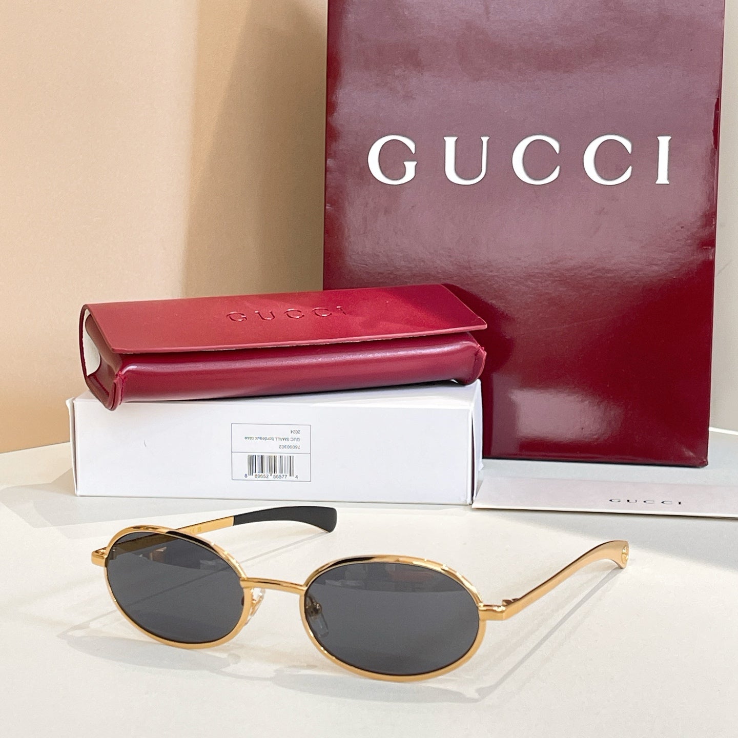 Gucci sunglasses with dark lenses and gold-tone round frames