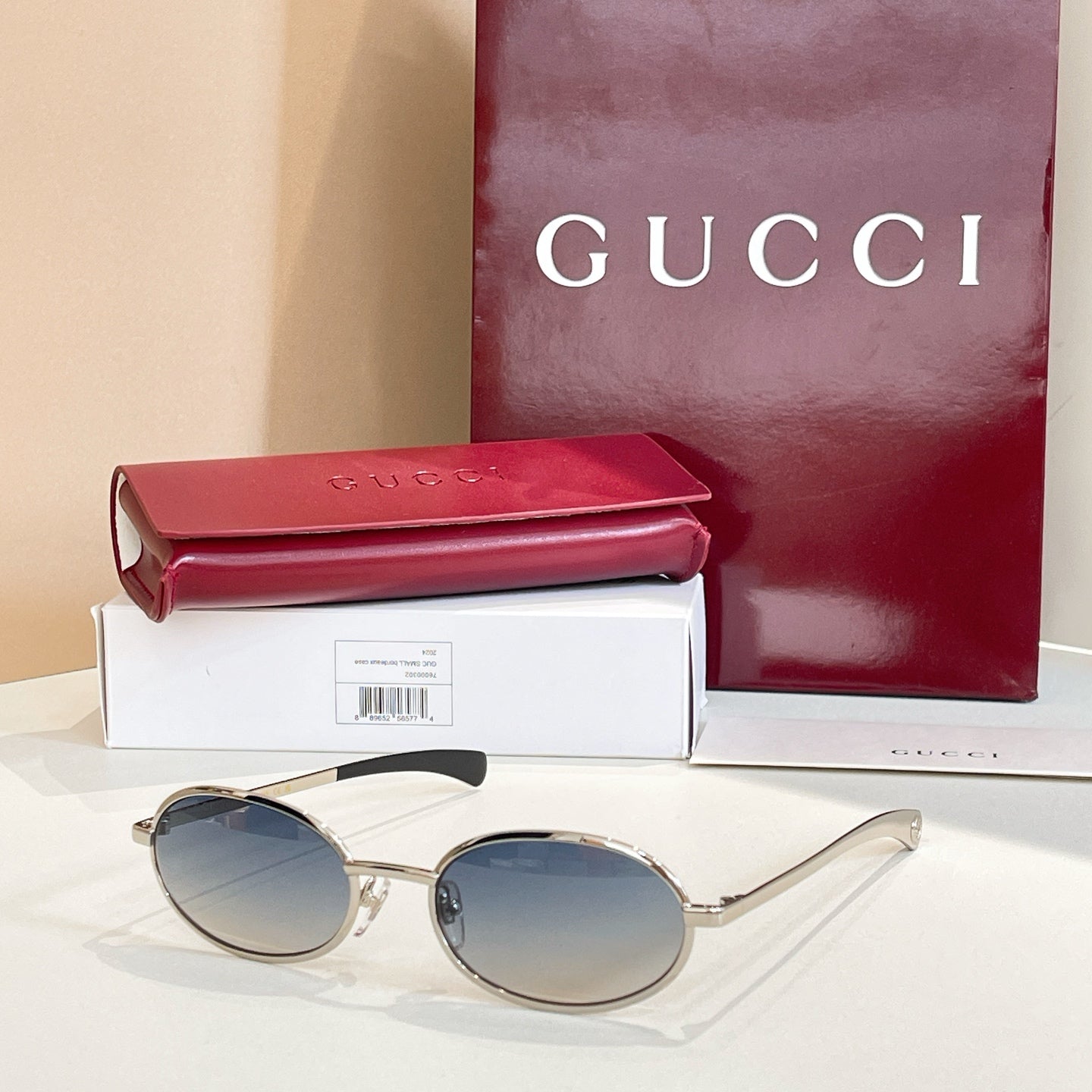 Gucci sunglasses with dark lenses and silver-tone round eyeglass frames