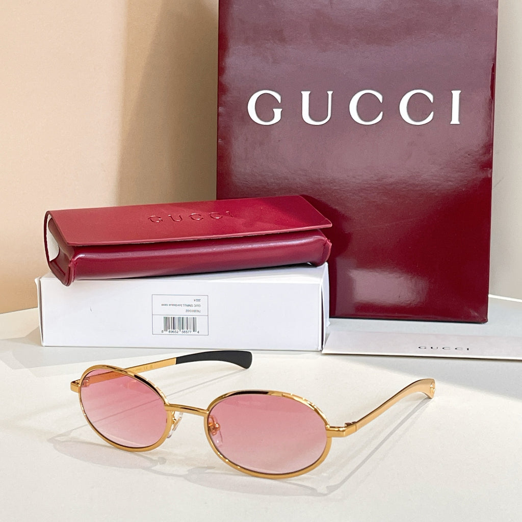Gucci sunglasses with pink lenses and gold-tone round frames