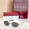 Gucci sunglasses with dark lenses and silver-tone round frames