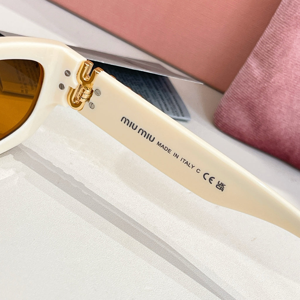 MiuMiu cream sunglasses temple with gold-tone hardware and Made in Italy text