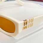 MiuMiu cream sunglasses front view with amber lenses and gold-tone Miu Miu logo