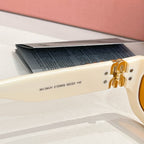 MiuMiu cream sunglasses temple with engraved model code and gold-tone logo