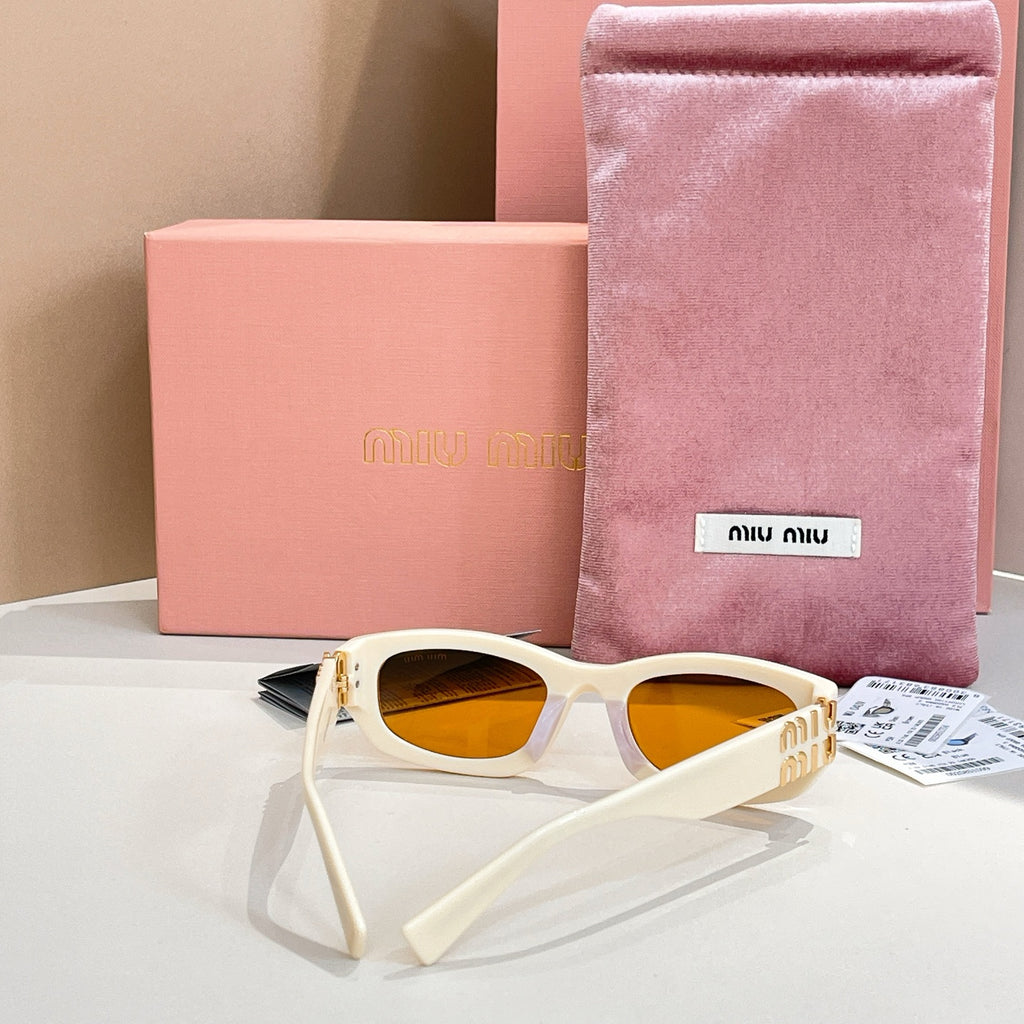 MiuMiu cream sunglasses with amber lenses, gold-tone logo and matching temple tips