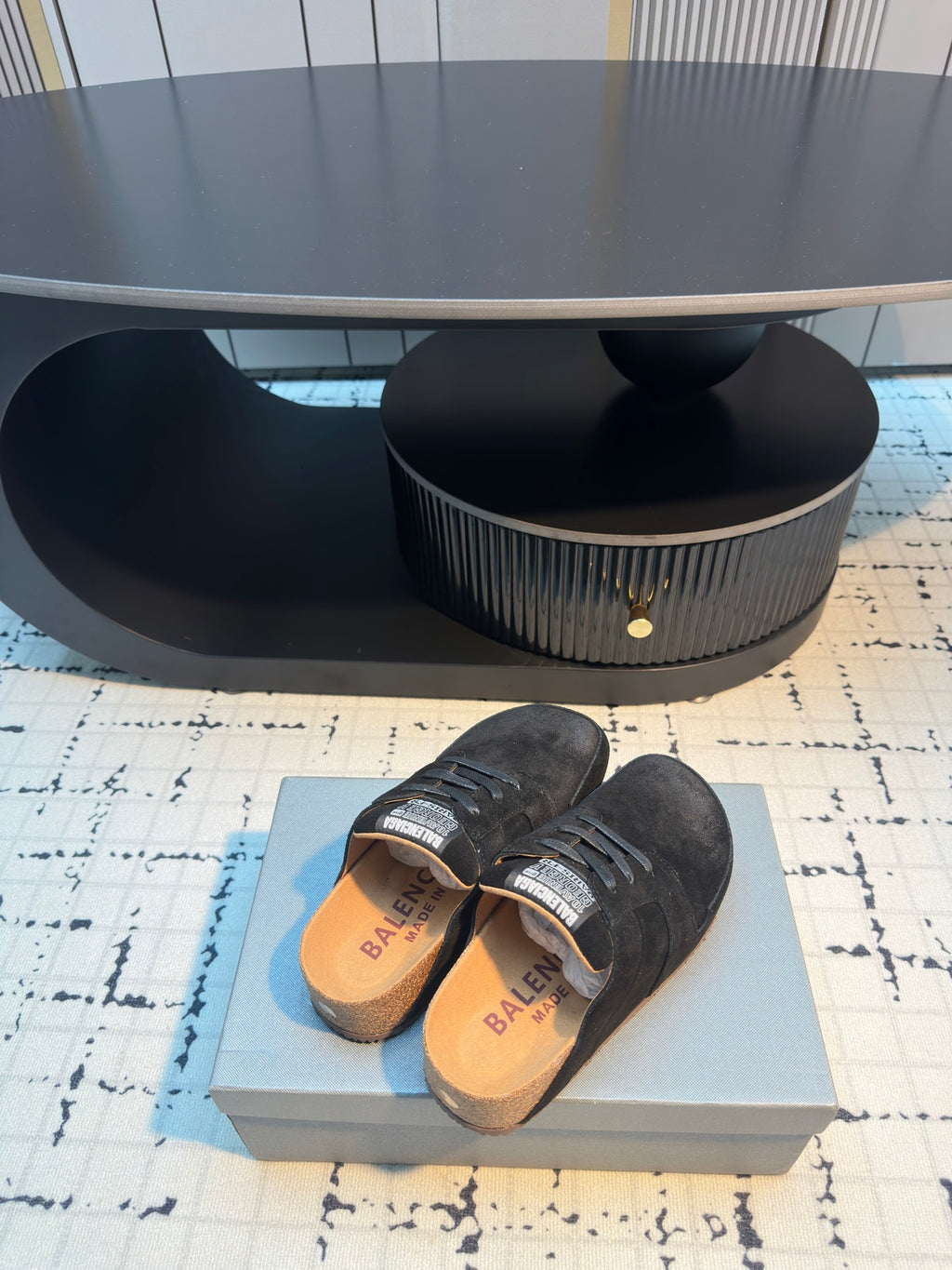 Balenciaga black lace-up slip-on shoes, stacked pair showing insoles and heel area.