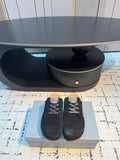 Balenciaga black lace-up slip-on shoes with suede upper and textured sole.