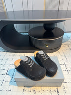 Balenciaga black lace-up slip-on shoes, side view pair with contrast sole tread.