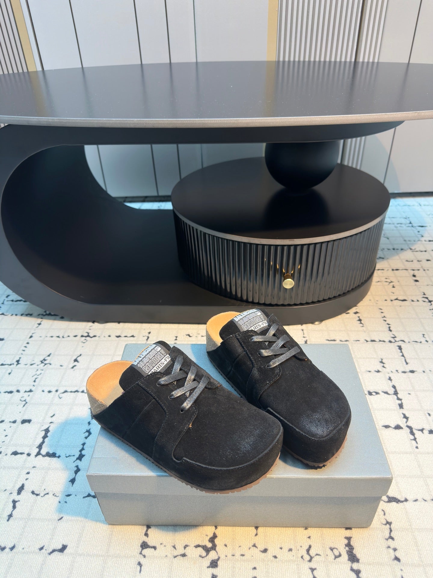Balenciaga black lace-up slip-on shoes, side view pair with contrast sole tread.