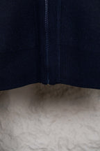 Navy knit cardigan with center zipper and ribbed bottom hem