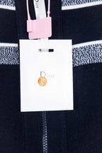 Dior clothing tag and price card attached to navy knit zip cardigan