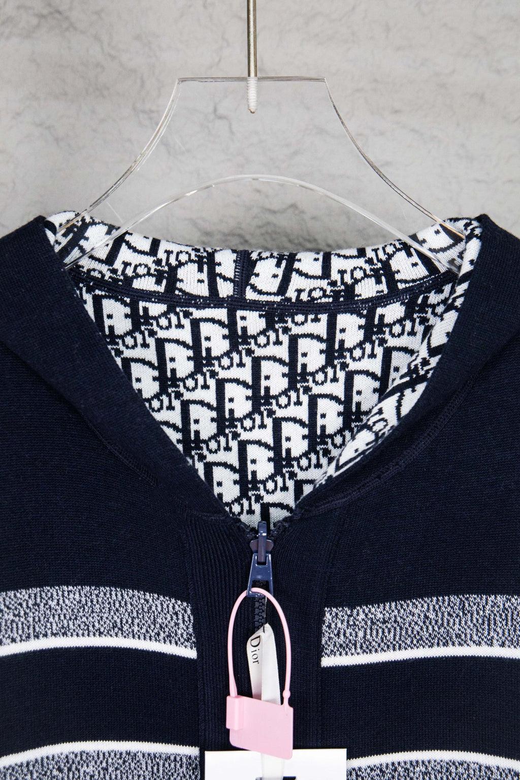 Navy zip-up cardigan with patterned inner hood and front zipper pull