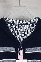Navy zip-up cardigan with patterned inner hood and front zipper pull