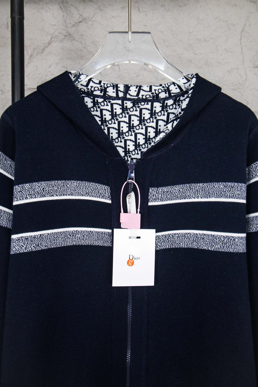 Navy zip-up cardigan with patterned hood lining and front zipper