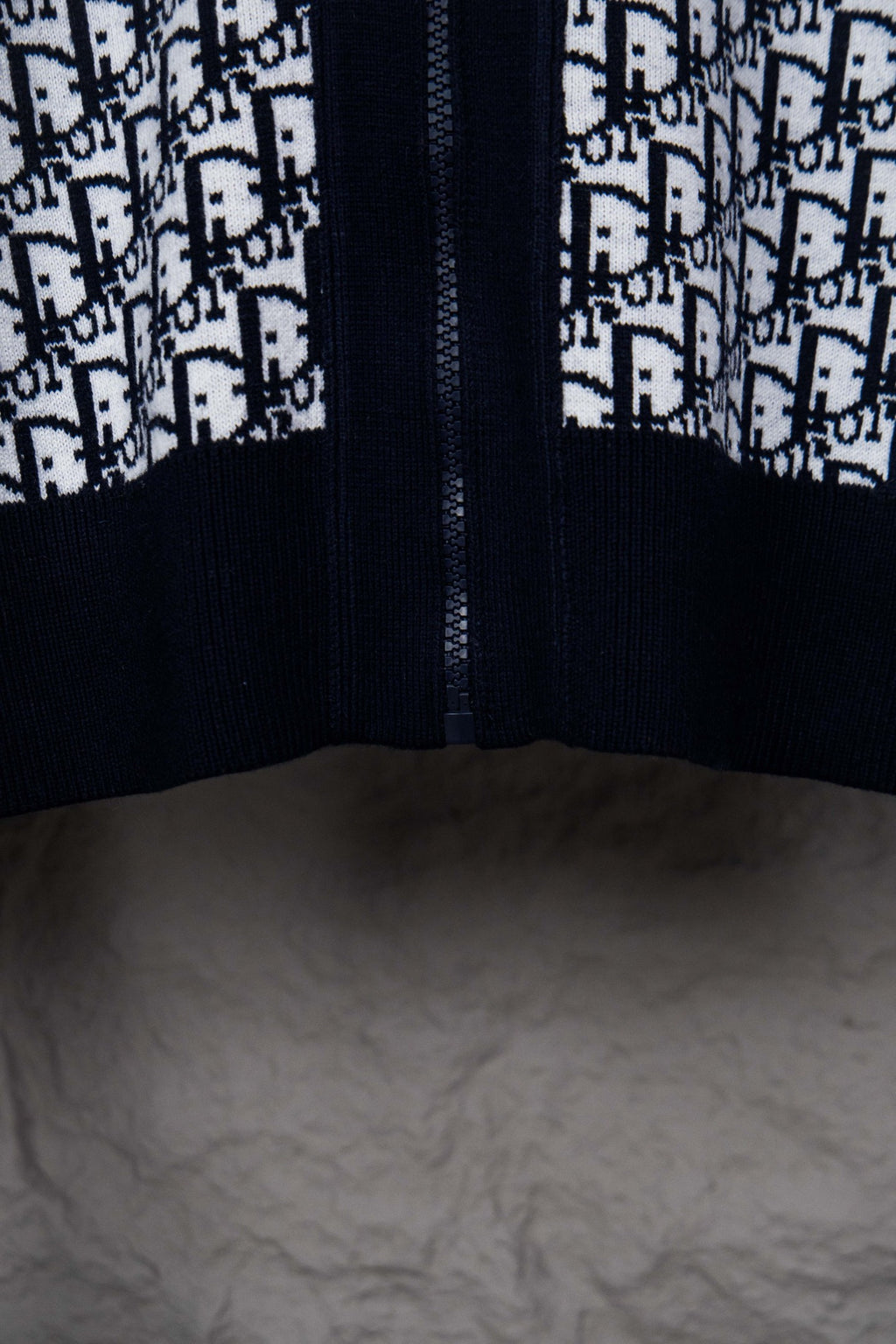 Dior knit jacket front view with centered zipper seam and monogram pattern