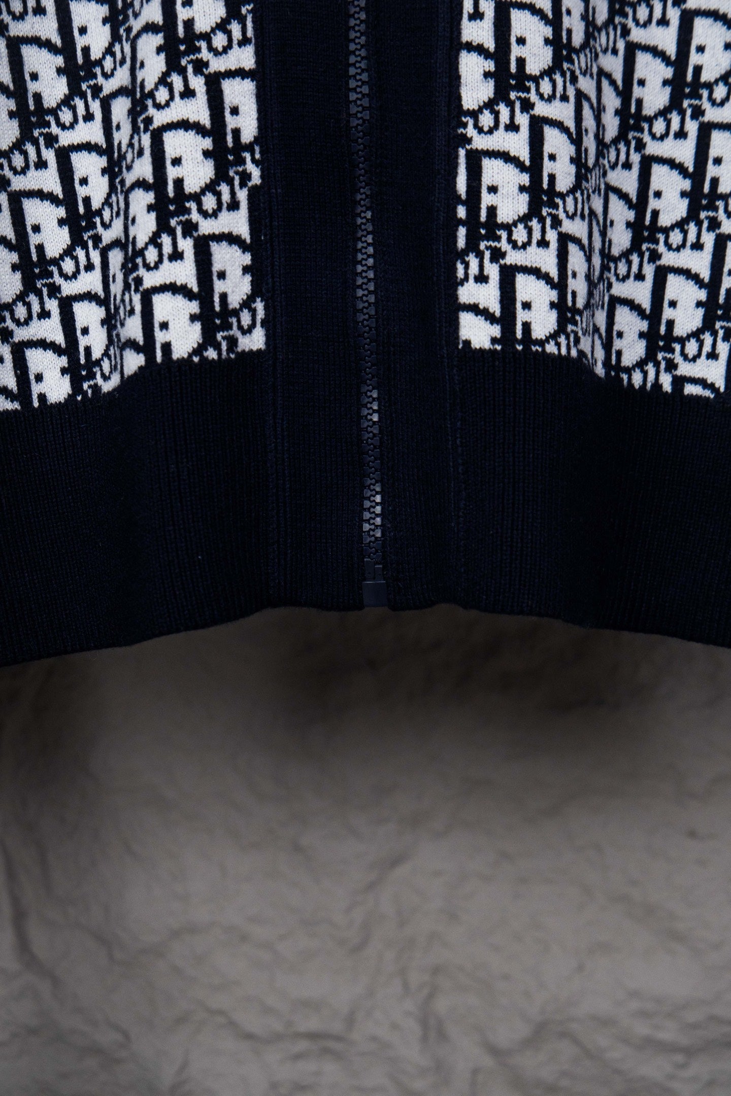 Dior knit jacket front view with centered zipper seam and monogram pattern