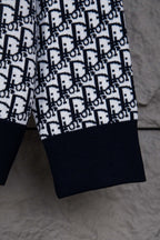Dior knit jacket sleeve with navy cuff and repeating monogram pattern