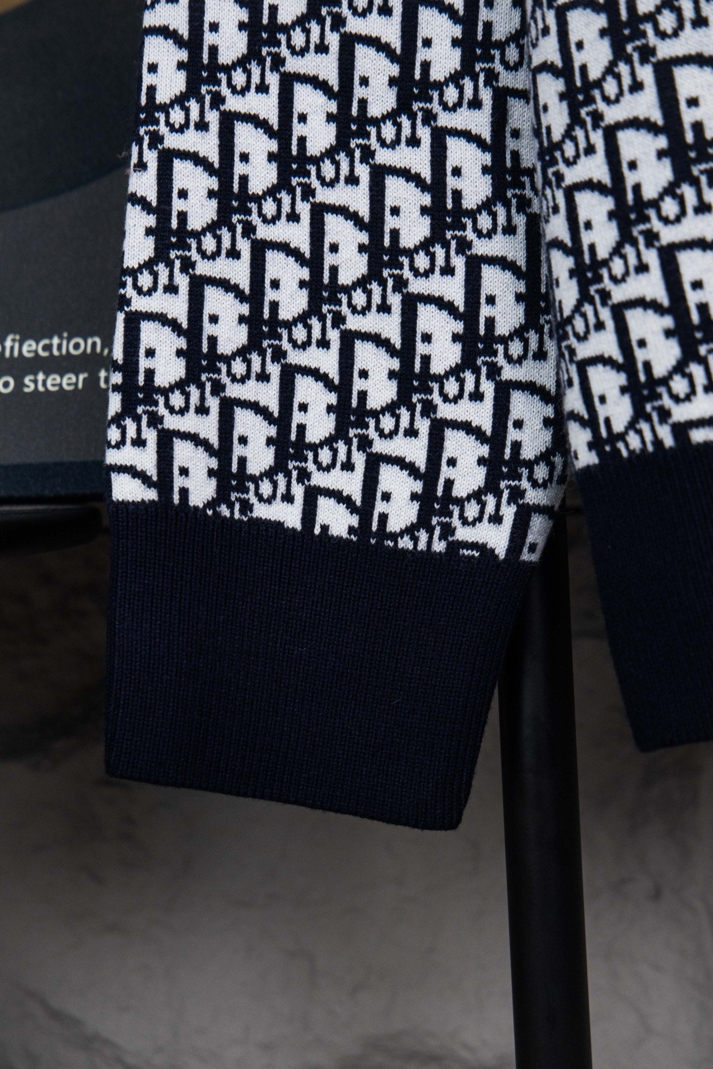 Dior knit jacket lower body with navy ribbed hem and repeating monogram pattern