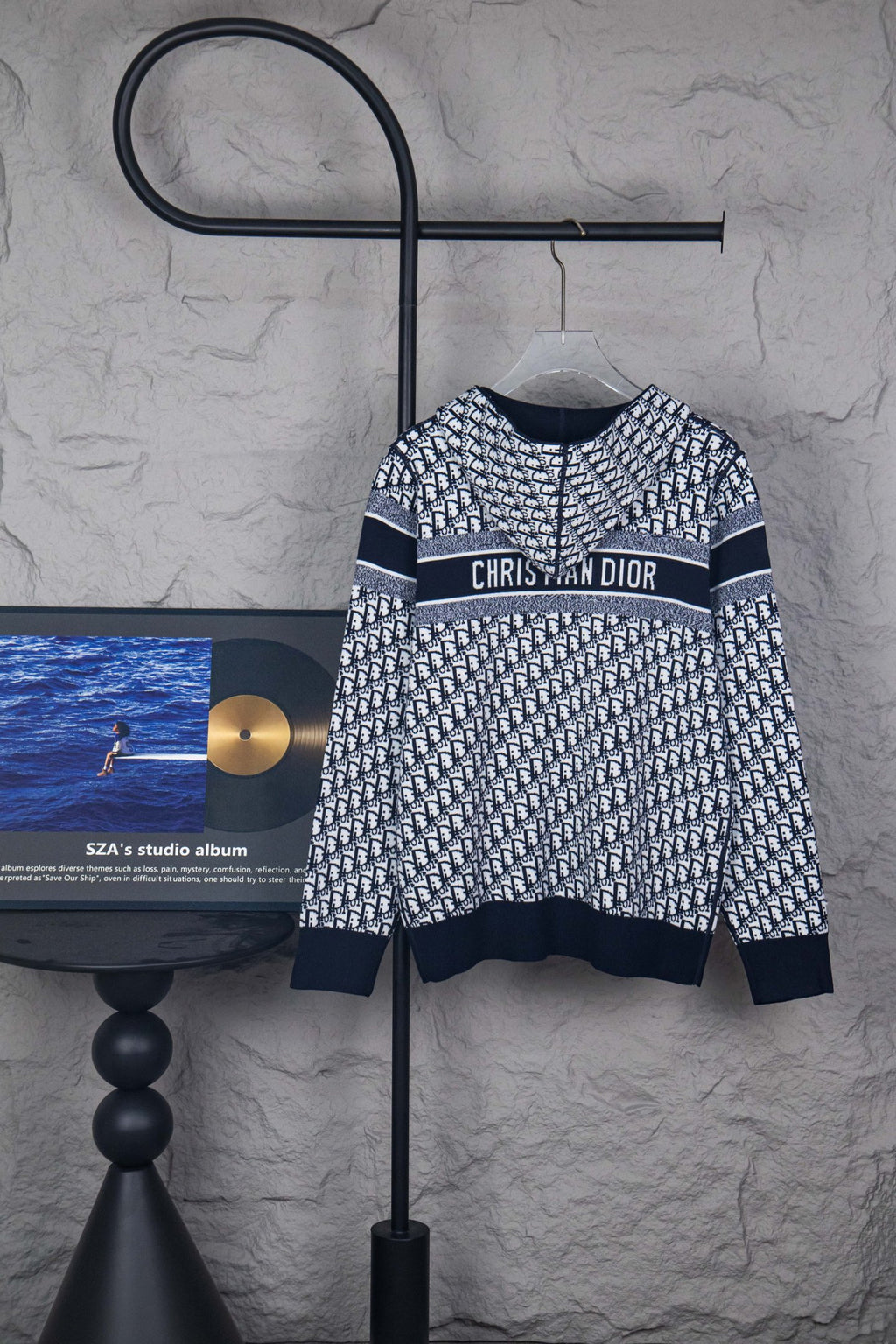 Dior knit jacket with navy/white monogram pattern and “CHRISTIAN DIOR” band across chest