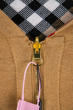 Burberry tan jacket zipper close-up with check lining and dangling charm