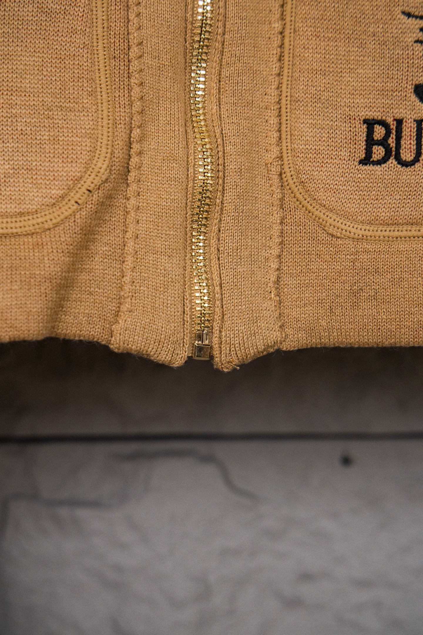 Burberry tan zip hoodie with front zipper and ribbed cuffs, close-up