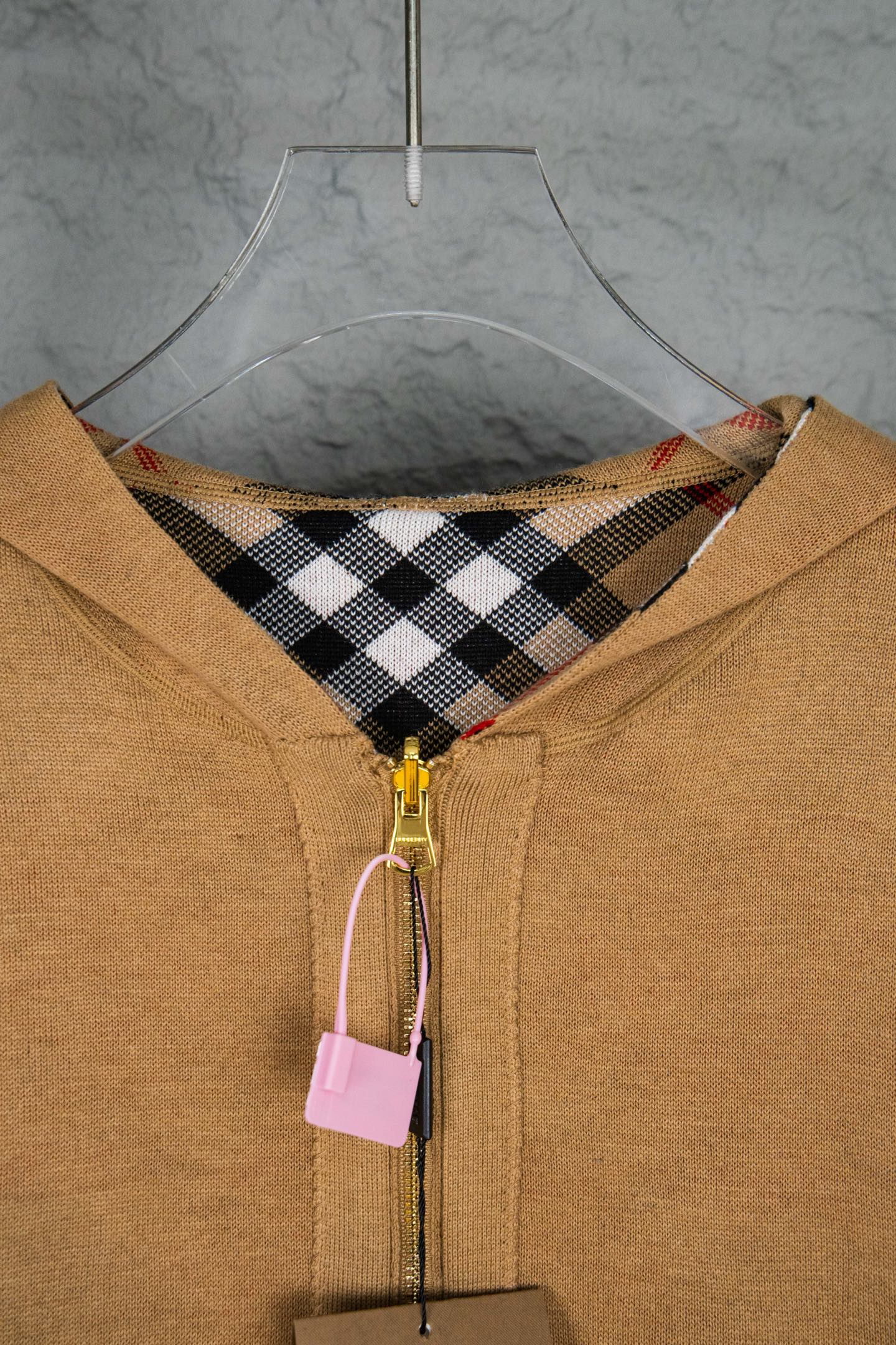 Burberry tan hooded knit jacket showing check interior hood and gold zipper pull