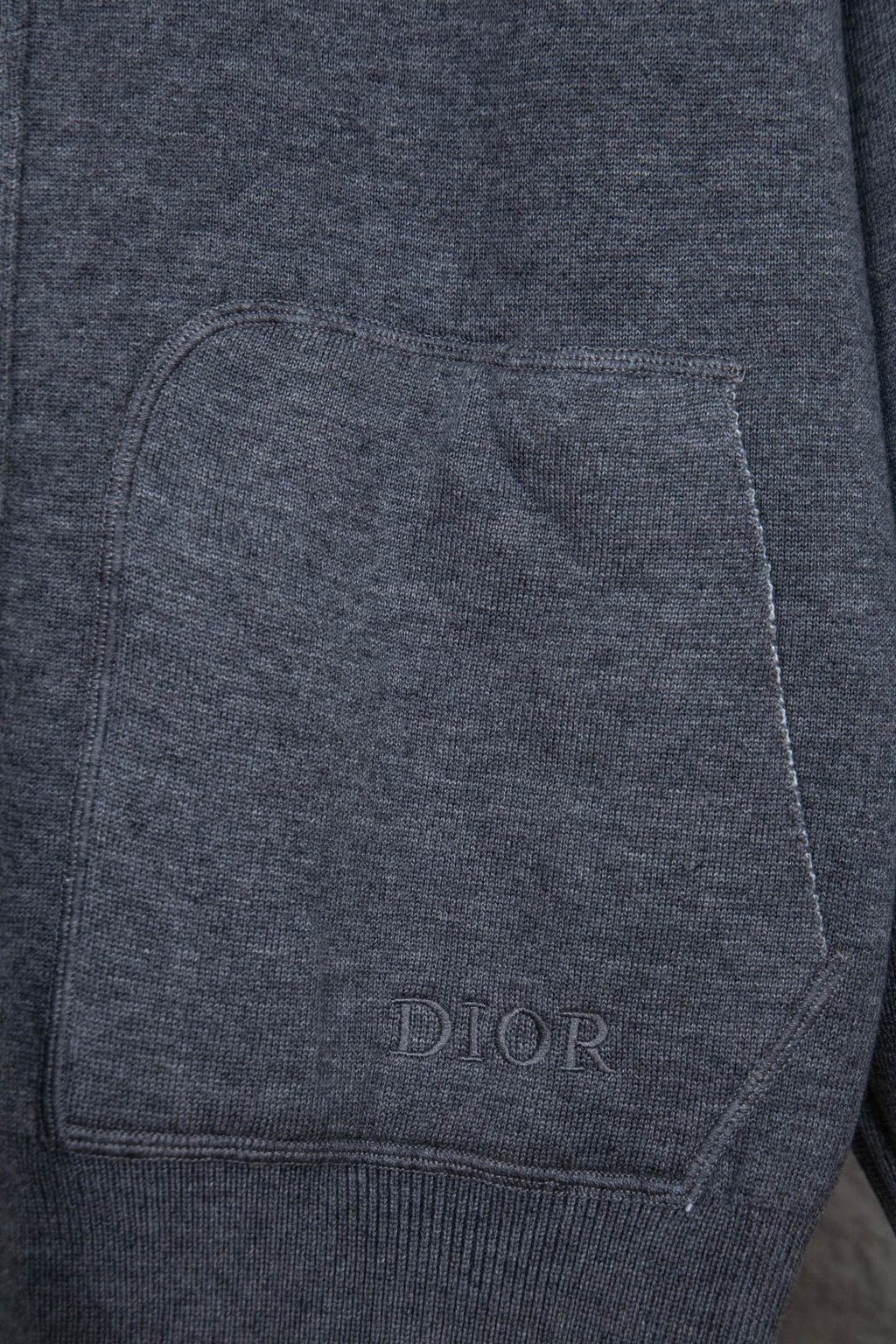 Heather gray front pocket with stitched edges and small DIOR text