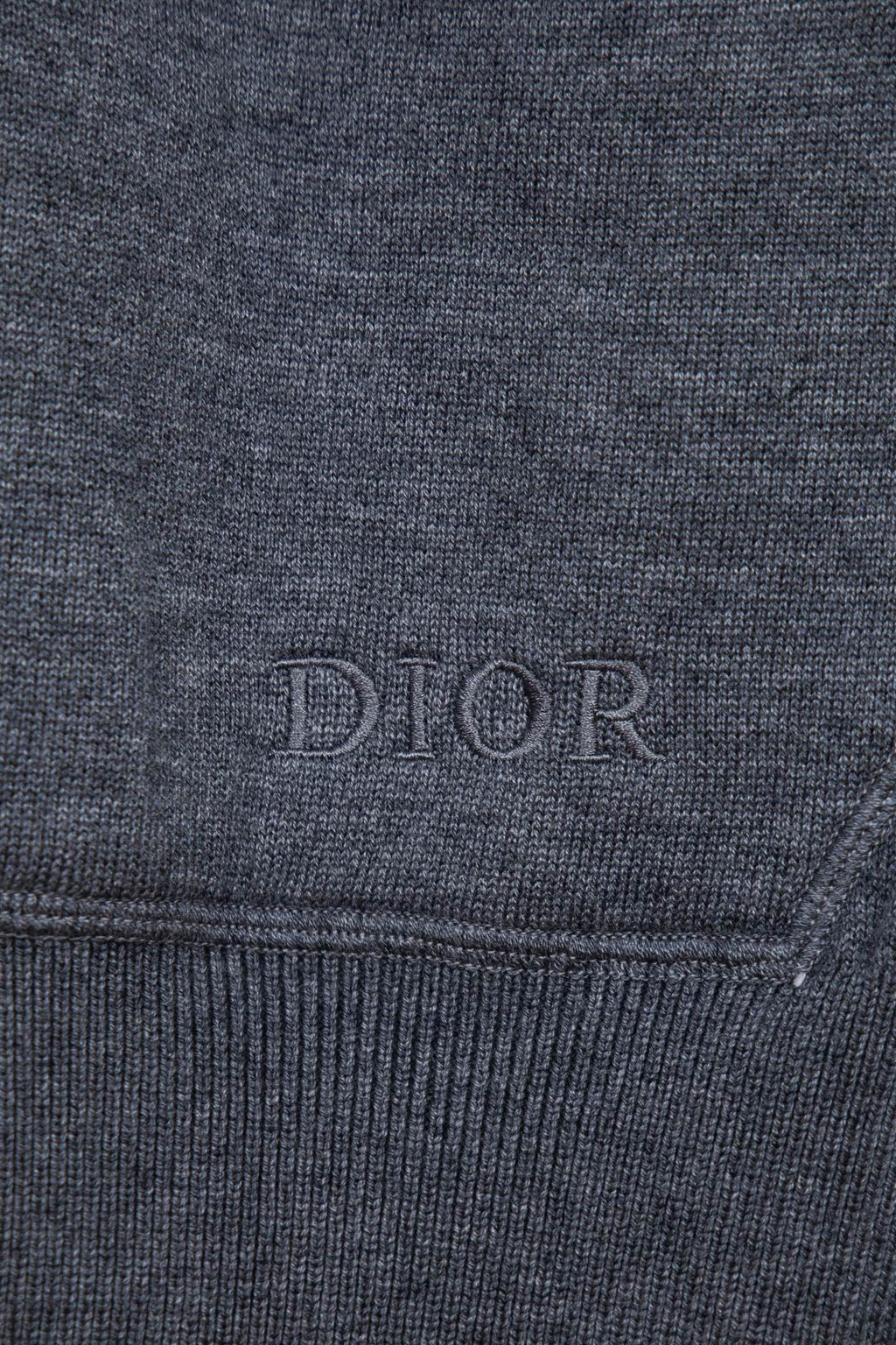 Heather gray hoodie cuff with subtle DIOR embroidery on the hem