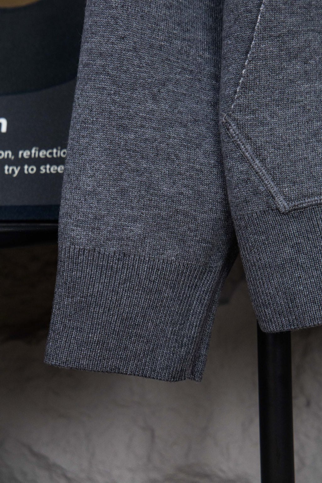 Heather gray hoodie sleeve with ribbed cuff and visible side seam