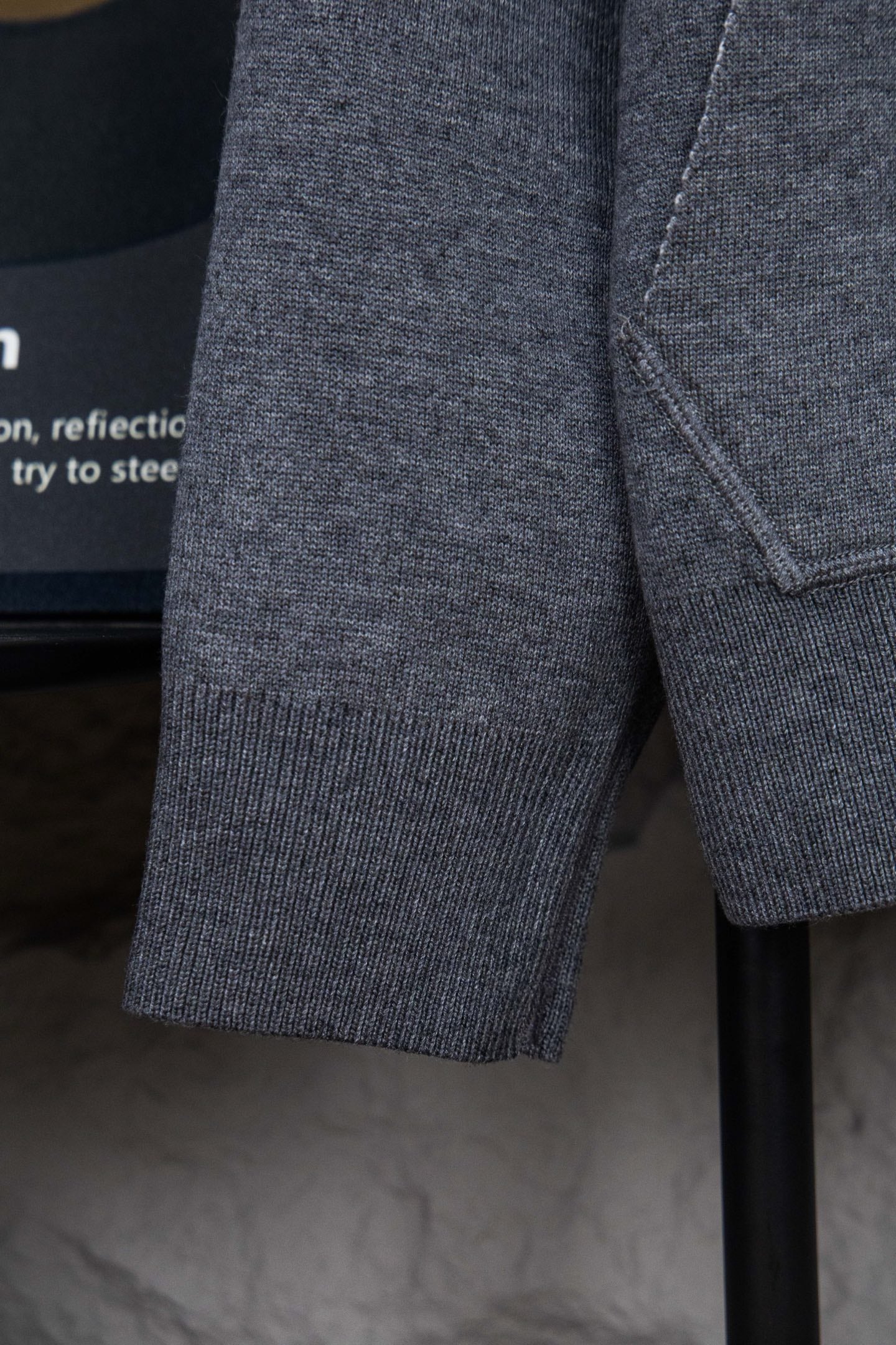 Heather gray hoodie sleeve with ribbed cuff and visible side seam