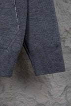 Heather gray hoodie hem with ribbed cuffs and side seam stitching
