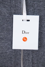 Heather gray zip hoodie with hanging white Dior tag on zipper