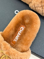 Close-up of tan Chanel fuzzy slide slipper interior with CHANEL label