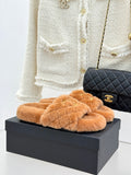 Tan fuzzy Chanel slide slippers with gold Double C logo on the band