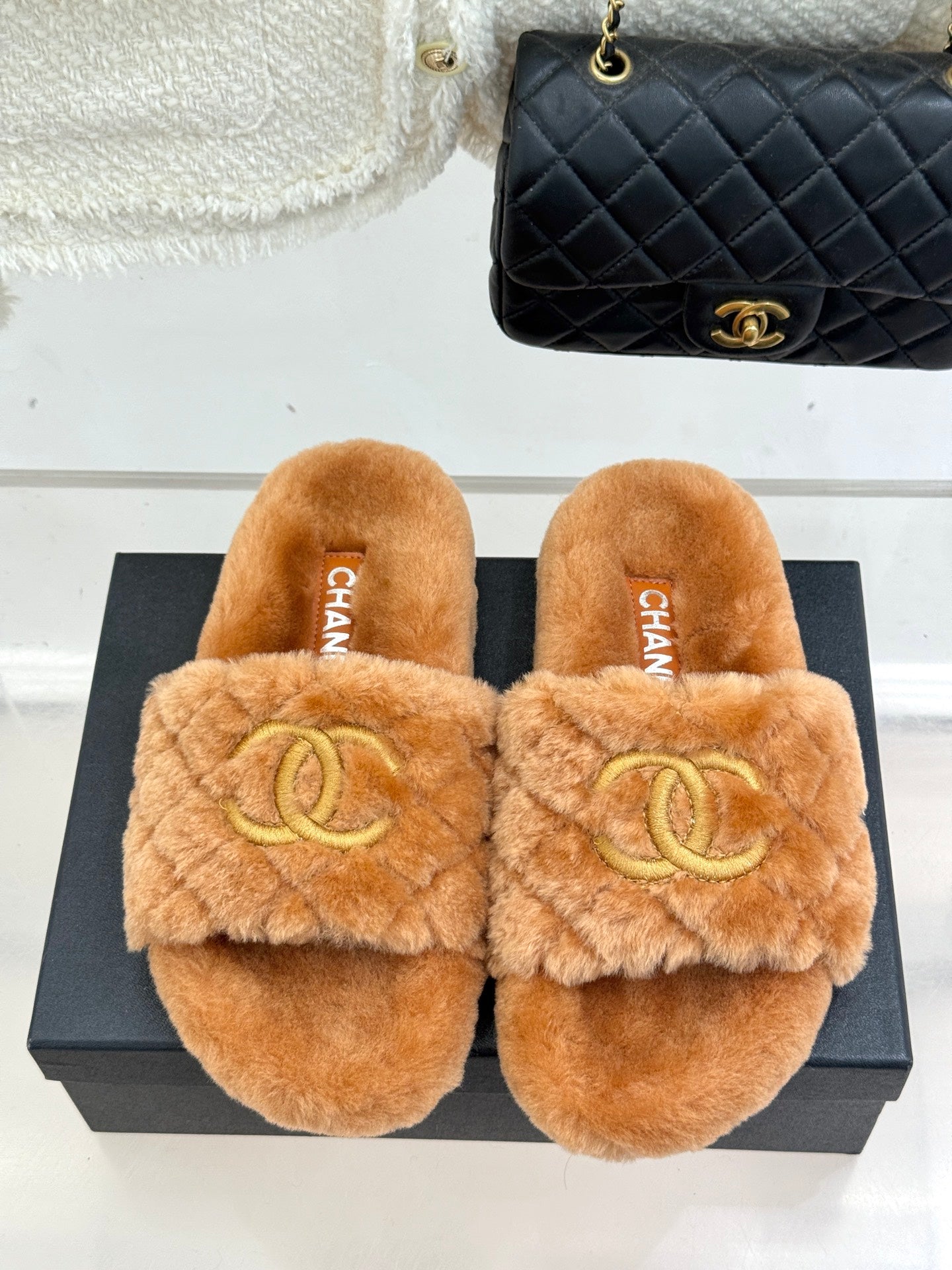 Tan Chanel fuzzy slide slippers with gold Double C logo, front view
