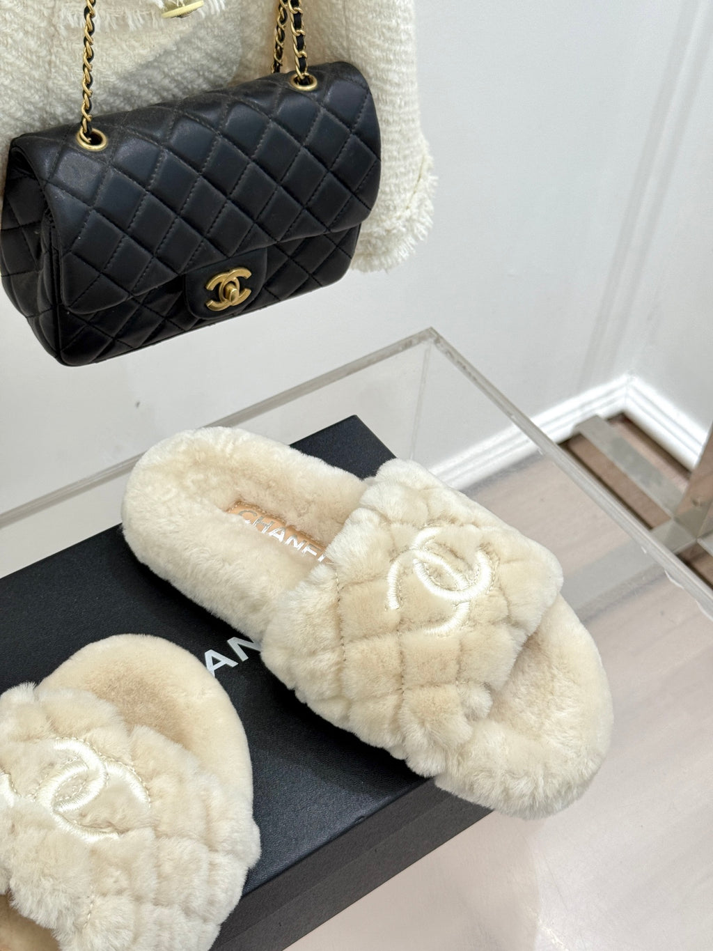 Cream plush slide sandals with double-C logo, shown on black display box