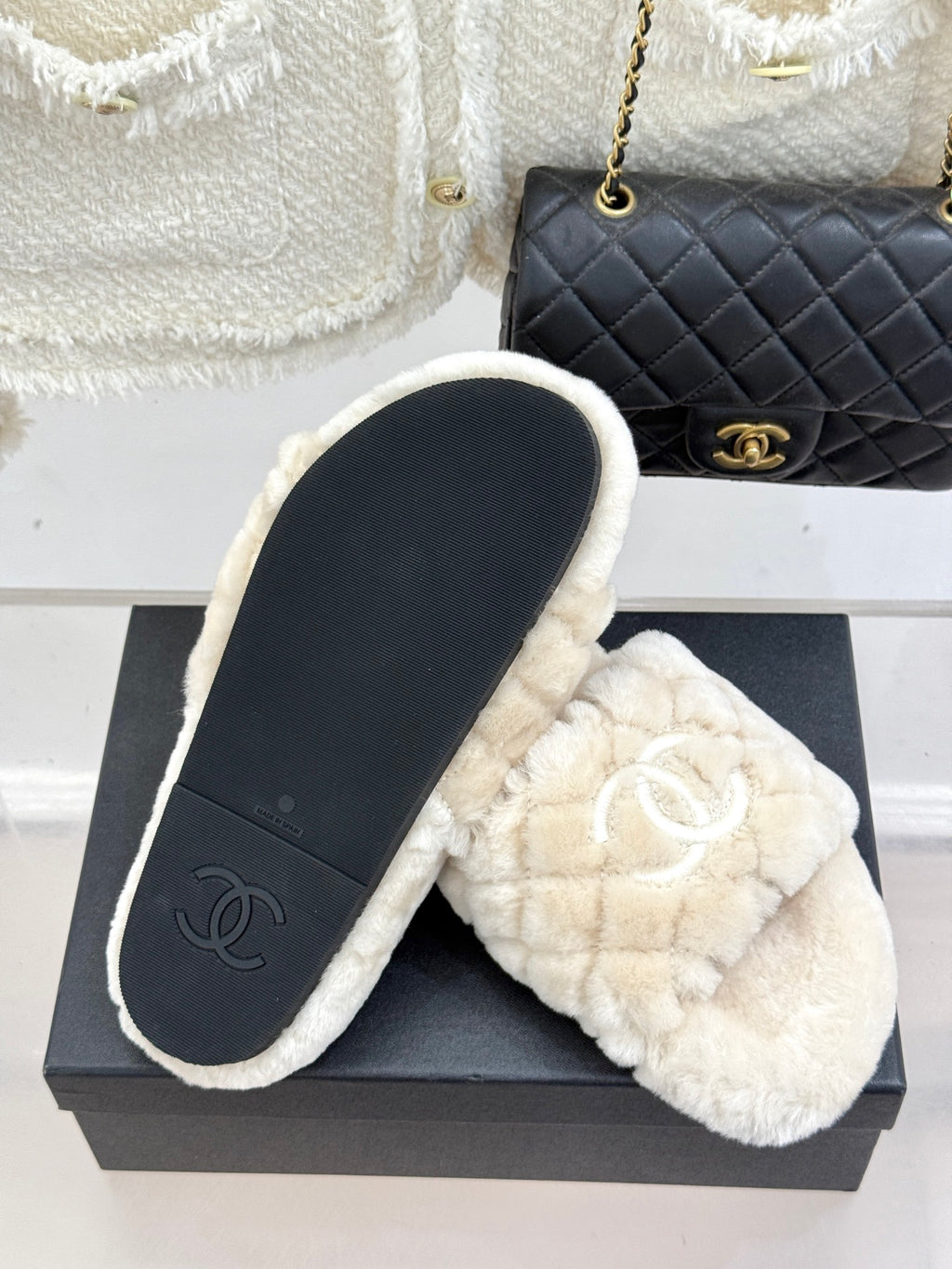 Cream plush slide sandals with double-C logo; sole and insole visible